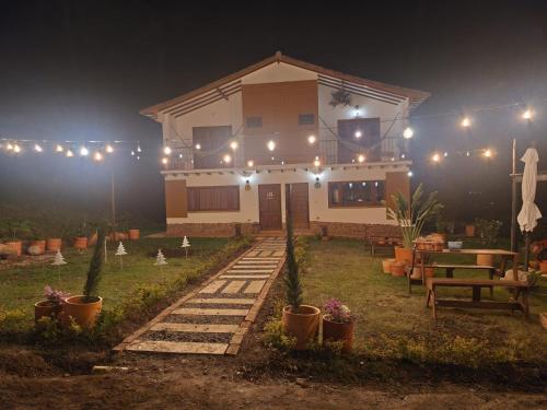 a house with lights in the yard at night at Hotel Ficus Villa de Leyva in Villa de Leyva