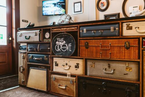 a bunch of suitcases stacked on top of each other at The Grove Hotel in Kingsville