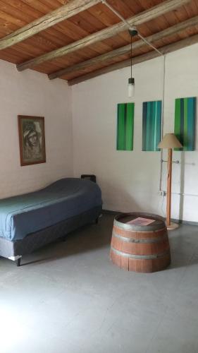 a bedroom with a bed and a wooden ceiling at Tiempo de Bienestar in Potrerillos