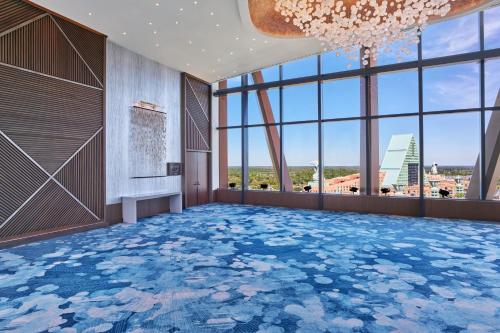 a large room with a chandelier and a blue floor at Walt Disney World Swan Reserve in Orlando