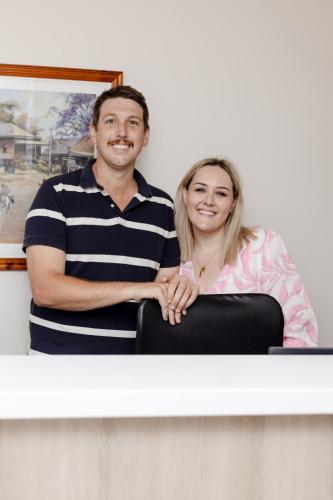 a man and a woman sitting at a counter at Starline Motor Inn in Miles