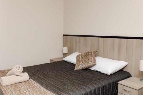 a bedroom with a bed with two pillows at Starline Motor Inn in Miles