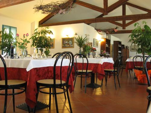 une salle à manger avec une table et des nappes rouges dans l'établissement Hotel Rurale Canneviè, à Lido di Volano