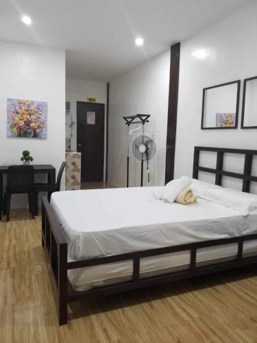 a bedroom with a bed with a dog laying on it at JSS PENSION HOUSE in Can-asujan