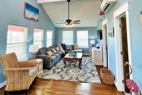 a living room with a couch and a table at The Pink Flamingo Beach Gulf views in Freeport