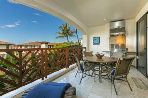 a balcony with a table and chairs and a kitchen at Wailea Beach Villas by Coldwell Banker Island Vacations in Wailea