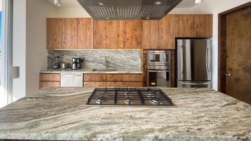 a kitchen with a stove top in the middle of a bed at New 5 Br + Pool Luxury Beach Home Vista Hermosa in Puerto Peñasco
