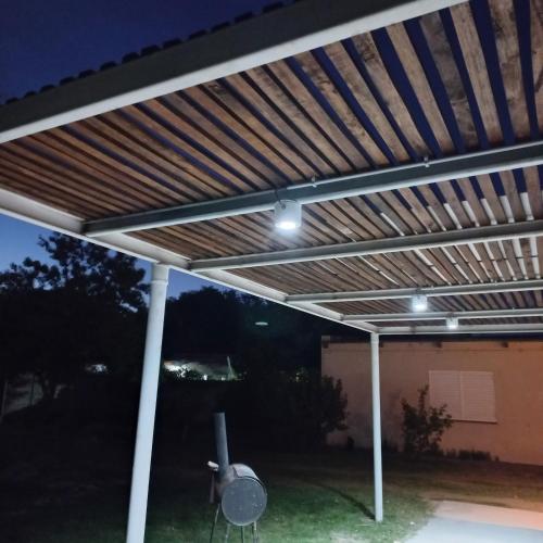 a pergola with lights on a patio at Alquiler por dia en choele. Depto 5 in Choele Choel