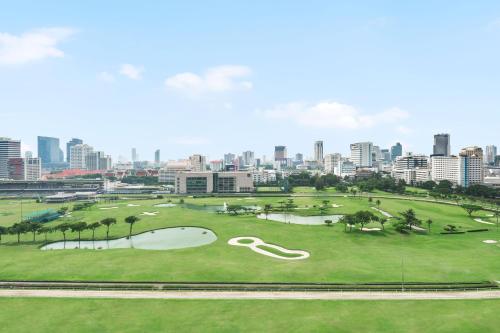 a golf course with a city in the background at The St. Regis Bangkok in Bangkok