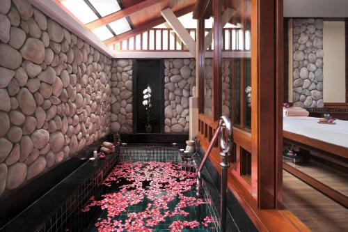 a bathroom with a carpet of pink flowers on the floor at Phuket Marriott Resort & Spa, Merlin Beach in Patong Beach