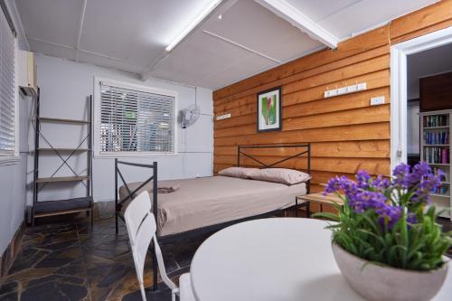 a bedroom with a bed and a table and chairs at Cairns City Backpackers Hostel in Cairns