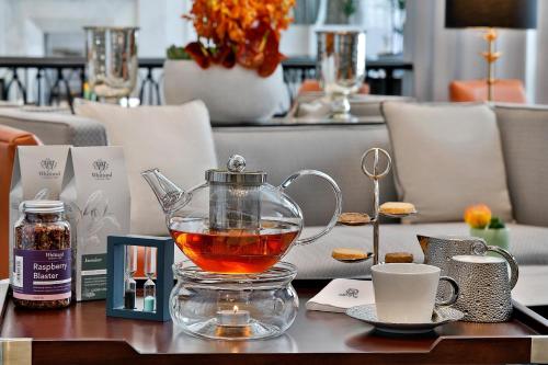 a glass teapot with tea in it on a table at The St. Regis Amman in Amman