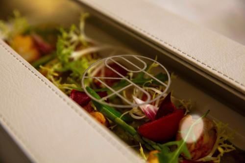 a box full of salad ingrediants on top of sidx sidx at The St. Regis Amman in Amman