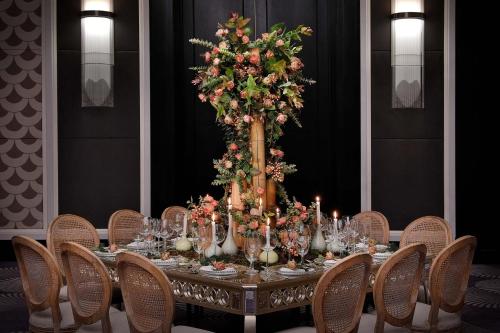 a table with a large floral arrangement on top of it at The St. Regis Amman in Amman