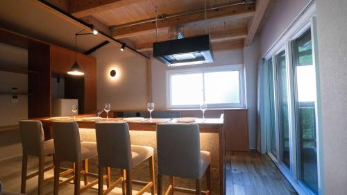 a dining room with a table and chairs and a window at Hotel Re:Plug in Kochi