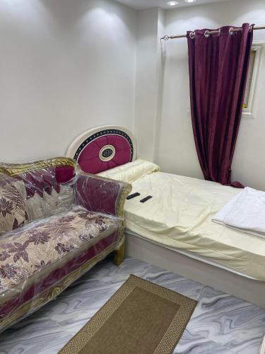 a small room with two beds and a window at ستديو فندقي in 6th Of October