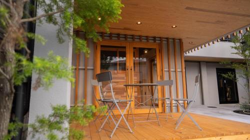 a porch with chairs and a table on a house at Hotel Re:Plug in Kochi