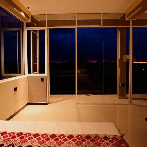 a bedroom with a bed and a large window at Eye Catch Kandy in Kandy