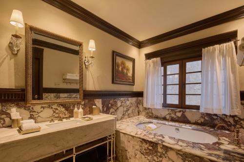 a bathroom with a tub and a large mirror at Todos Santos Boutique Hotel in Todos Santos