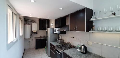 a kitchen with black and white appliances at Emilio Civit in Mendoza