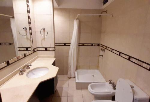 a bathroom with a sink and a toilet and a shower at Emilio Civit in Mendoza