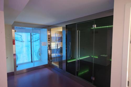 a glass walk in shower in a room at Hotel Milano & SPA***S in Verona