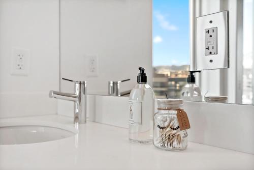 a bathroom counter with two bottles of soap and a sink at Hala DC in Washington