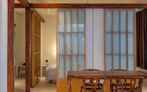 a dining room with a wooden table and chairs at Hotel Barahan Jeonju in Jeonju