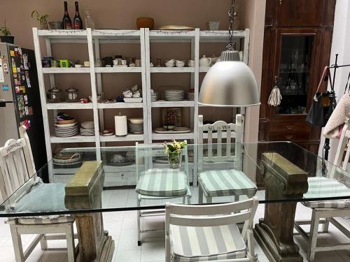 a dining room with a glass table and chairs at GABY'S HOME in Buenos Aires