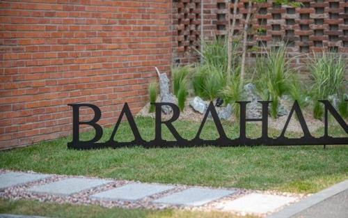 a sign that says balmain on the side of a brick building at Hotel Barahan Jeonju in Jeonju