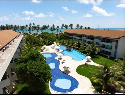 an aerial view of a resort with a swimming pool at Flat Beira Mar - Carneiros Beach Resort in Tamandaré