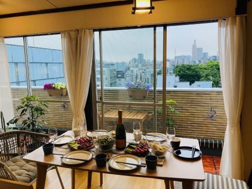 a table with a bottle of wine on a balcony at 新宿区早稻田地铁6分钟两室景观公寓 in Tokyo