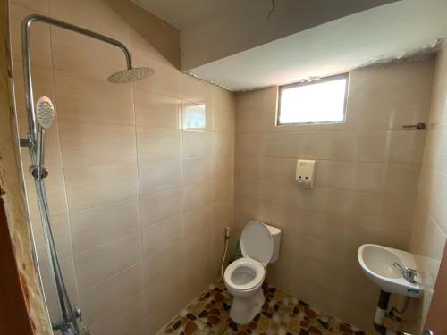 a bathroom with a toilet and a sink at Balinese Villa Syariah in Sekupang