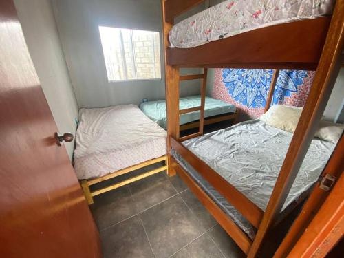 a small room with two bunk beds in it at Casa Colan La Molina in Paita