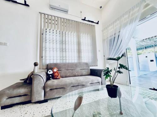a living room with a couch and a glass table at Gioia2Home 5 mins to Taiping/Kamunting in Taiping