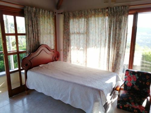 a bedroom with a bed and a large window at Finca villa carolina, eje cafetero in La Floresta