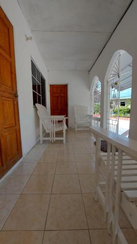 a room with a table and chairs on a floor at Holiday rooms in St Thomas Jamaica in Clifton