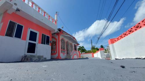 a church with an orange and white building at Holiday rooms in St Thomas Jamaica in Clifton