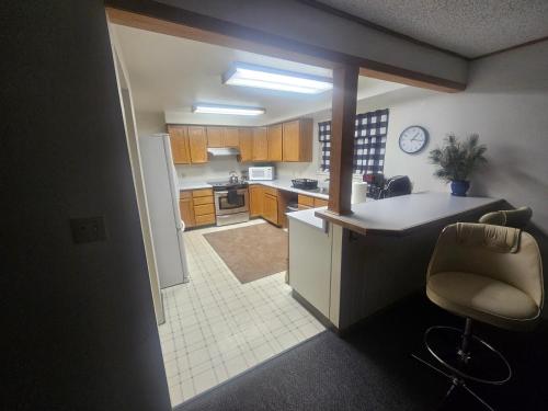 a kitchen with a counter and a chair in it at Downtown Aurora house #1 in Fairbanks