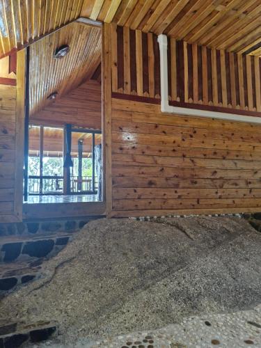 an inside view of a wooden building with a window at Mai Pen Rai Bungalows in Than Sadet Beach