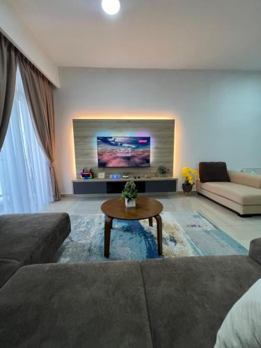 a living room with a couch and a coffee table at Al Mansor Islamic Guestroom in Seremban