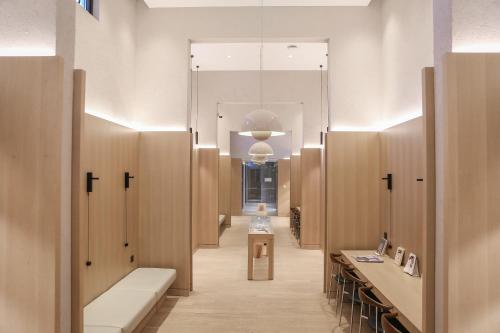 a hallway of a hospital with wooden wardrobes and benches at Read and Rest Hotel in Beijing