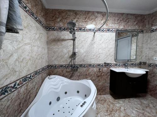 a bathroom with a bath tub and a sink at Apartment with a Nile View, Cairo, Maadi- شقه مطله بالكامل على النيل مباشره in Cairo