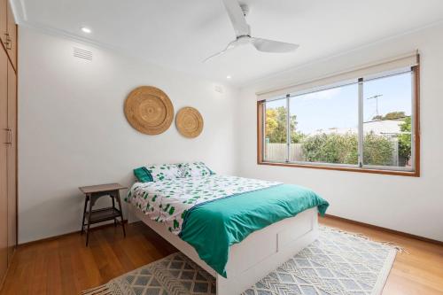 a bedroom with a bed and a window at Lonnie Getaway in Point Lonsdale