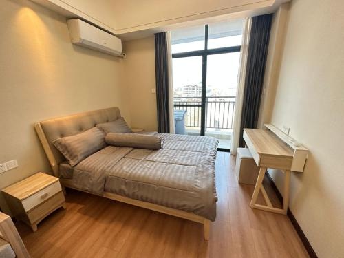 a small bedroom with a bed and a window at Brand New Modern Luxury Studio Apartment at the Heart of Vientiane in Vientiane