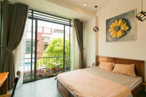 a bedroom with a bed and a large window at Siro homestay in Danang