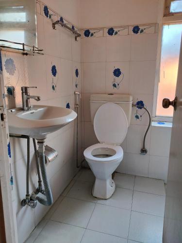 a bathroom with a toilet and a sink at Family Peace House, Kathmandu in Kathmandu