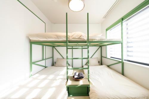 a bedroom with two bunk beds and a window at コートヤード広尾 in Tokyo