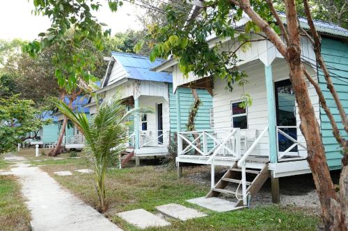 a blue and white house with a porch at Sandy Beach Bungalows in Koh Rong Sanloem