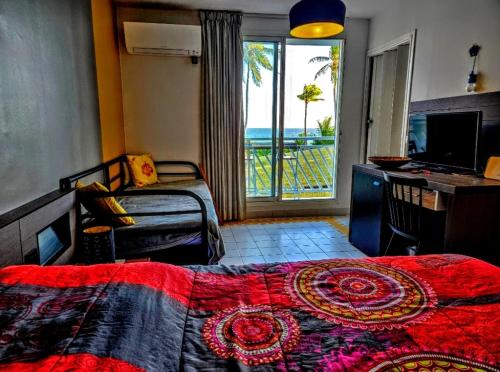 a bedroom with a bed and a view of the ocean at Caribbean sea view in Saint-François